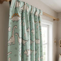 Mint green nursery curtain fabric with cartoon dinosaurs and tiny egg details.