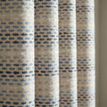 Blue horizontal stripe curtain fabric with raised woven dot texture.