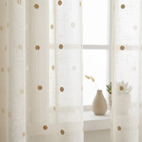 Beige sheer curtain panel with delicate embroidered dots.