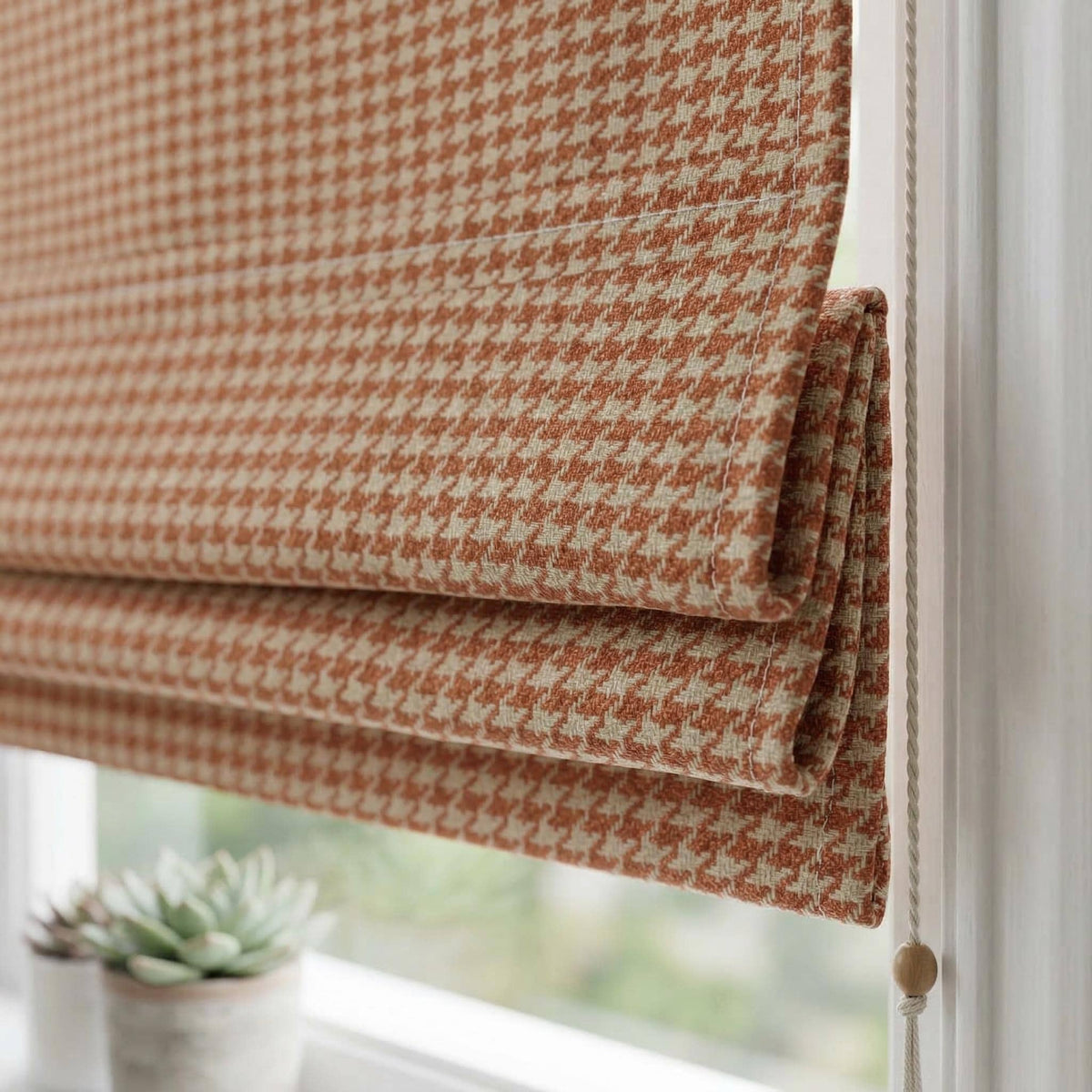 Terracotta houndstooth fabric used for a custom Roman shade.