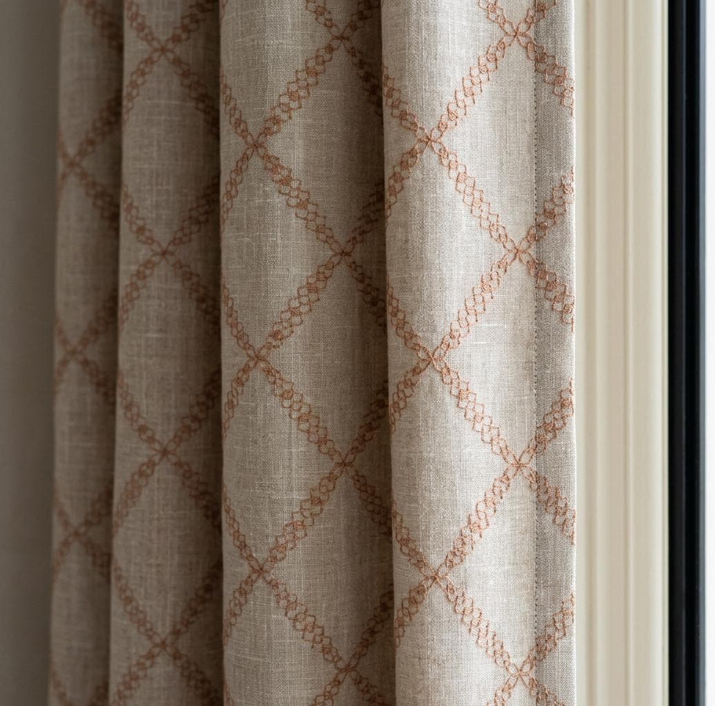 Curtain panel with an embroidered geometric trellis pattern.
